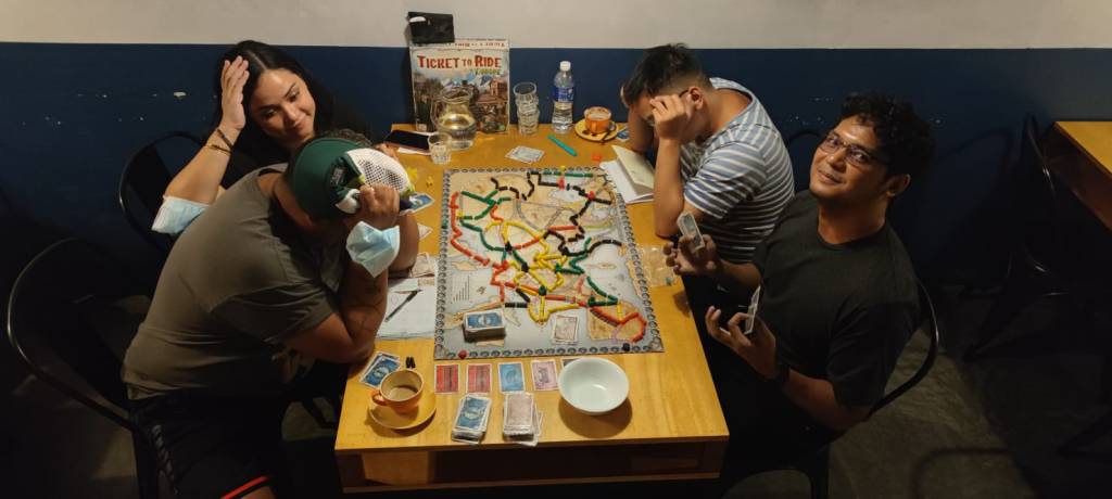 with Mark, his wife Maria, and Francis playing a board game